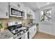 Well-equipped kitchen with granite countertops, stainless steel appliances, and bright windows at 1839 Belcher Pl, Austell, GA 30168