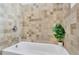 Modern bathroom with a tiled shower and decorative green plant at 1839 Belcher Pl, Austell, GA 30168
