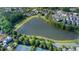 Aerial view of community with lake, walking path, and tennis court at 6575 Eli Davis Rd, Cumming, GA 30040