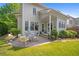 Landscaped backyard with a patio and manicured lawn outside the home at 6575 Eli Davis Rd, Cumming, GA 30040