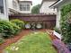 This cozy backyard has new plants, a lattice fence, and a well-manicured lawn at 6575 Eli Davis Rd, Cumming, GA 30040