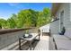 Inviting outdoor balcony with ample seating and scenic views of lush trees at 6575 Eli Davis Rd, Cumming, GA 30040