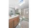 Bright bathroom featuring a skylight, vanity, and walk-in shower at 6575 Eli Davis Rd, Cumming, GA 30040