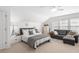 Bright bedroom with vaulted ceiling, white shiplap walls, bed, and sofa at 6575 Eli Davis Rd, Cumming, GA 30040
