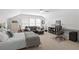 Bright bedroom with vaulted ceiling, white shiplap walls, bed, sofa, and desk at 6575 Eli Davis Rd, Cumming, GA 30040