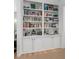 Built-in bookshelves featuring an extensive collection of books and decorative items at 6575 Eli Davis Rd, Cumming, GA 30040