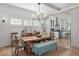 Charming dining room features a wooden table, bench seating, and elegant chandelier lighting at 6575 Eli Davis Rd, Cumming, GA 30040