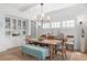 Elegant dining room with built-in cabinets, wooden table, and ample natural light from large windows at 6575 Eli Davis Rd, Cumming, GA 30040