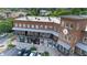 Charming brick building featuring a clock tower, covered patios, ample parking, and convenient access to shops at 6575 Eli Davis Rd, Cumming, GA 30040