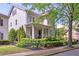 Charming two-story home features a covered porch with manicured landscaping at 6575 Eli Davis Rd, Cumming, GA 30040