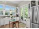 Bright kitchen features a farmhouse sink, stainless refrigerator, and backyard access at 6575 Eli Davis Rd, Cumming, GA 30040