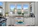 Bright kitchen with farmhouse sink, stainless steel appliances, and granite countertops at 6575 Eli Davis Rd, Cumming, GA 30040