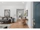 Stylish living room featuring hardwood floors, a leather sofa, and modern decor at 6575 Eli Davis Rd, Cumming, GA 30040
