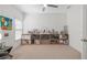 Large room with a window, ceiling fan, and long shelf for storage and decor at 6575 Eli Davis Rd, Cumming, GA 30040