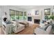 Bright living room with large windows, a fireplace, and comfortable seating arrangement at 6575 Eli Davis Rd, Cumming, GA 30040