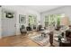 Bright living room featuring a decorative rug, stylish furniture, and abundant natural light at 6575 Eli Davis Rd, Cumming, GA 30040