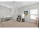 Bright living room featuring neutral walls, a ceiling fan, and desk at 6575 Eli Davis Rd, Cumming, GA 30040