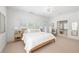 Bright bedroom with a large bed, neutral decor, and access to an outdoor balcony at 6575 Eli Davis Rd, Cumming, GA 30040