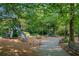Community playground offers slides and climbing structures for children to enjoy in a shady, tree-filled environment at 6575 Eli Davis Rd, Cumming, GA 30040