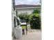 Cozy side porch with seating and a view of the well-maintained garden at 6575 Eli Davis Rd, Cumming, GA 30040