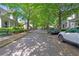 Neighborhood street view showcasing homes with mature trees and parked cars at 6575 Eli Davis Rd, Cumming, GA 30040
