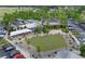 Aerial view of a vibrant town center featuring restaurants, shops, green space, and ample parking at 6575 Eli Davis Rd, Cumming, GA 30040
