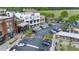 Aerial view of a town center showcasing shops, restaurants with outdoor seating, and organized parking at 6575 Eli Davis Rd, Cumming, GA 30040