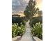 Stone walking path through lush, landscaped gardens at sunset at 6575 Eli Davis Rd, Cumming, GA 30040