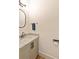 Neutral half bathroom with a sleek vanity and marble countertop at 686 Exchange Se St, Atlanta, GA 30315