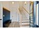 Bright foyer featuring wood floors, stairs, a chalkboard wall, and stylish light fixtures at 686 Exchange Se St, Atlanta, GA 30315