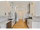 Modern kitchen with white cabinets, stainless steel appliances, and marble countertops at 686 Exchange Se St, Atlanta, GA 30315
