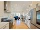Open-concept kitchen with white cabinetry, stainless steel appliances, and a view of the living area at 686 Exchange Se St, Atlanta, GA 30315
