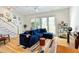 Spacious living room with hardwood floors, a plush blue couch, and ample natural light at 686 Exchange Se St, Atlanta, GA 30315