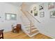 Bright staircase features hardwood steps, white risers, and decorative Star Wars themed art at 686 Exchange Se St, Atlanta, GA 30315