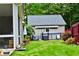 Landscaped backyard featuring a hot tub, lush lawn, and a blend of vibrant flowers and mature trees at 125 Murphy Creek Ln, Fayetteville, GA 30215