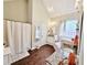 Bright bathroom featuring granite countertop, tub, walk-in shower, and wood floors at 125 Murphy Creek Ln, Fayetteville, GA 30215