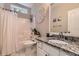 Bathroom boasts granite countertops, decorative mirror, and a tub/shower combination for a serene and stylish experience at 125 Murphy Creek Ln, Fayetteville, GA 30215