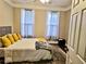 Comfortable bedroom featuring two windows offering natural light and a cozy, neutral color scheme at 125 Murphy Creek Ln, Fayetteville, GA 30215