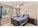Bedroom featuring carpet flooring, ceiling fan, and large window allowing an abundance of natural light at 125 Murphy Creek Ln, Fayetteville, GA 30215