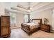 Comfortable bedroom with a tray ceiling, carpeted floor, and classic furniture creating a cozy retreat at 125 Murphy Creek Ln, Fayetteville, GA 30215