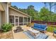Back deck with a blue outdoor sofa, fire pit, exterior access to screened porch, and private backyard at 125 Murphy Creek Ln, Fayetteville, GA 30215