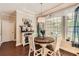 Bright dining area features a custom coffee bar and round wood table illuminated by elegant chandelier pendant light at 125 Murphy Creek Ln, Fayetteville, GA 30215