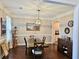 Dining room showcasing elegant lighting, wainscoting, and hardwood floors at 125 Murphy Creek Ln, Fayetteville, GA 30215