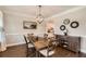Cozy dining room with dark hardwood floors, elegant lighting, and stylish decor at 125 Murphy Creek Ln, Fayetteville, GA 30215