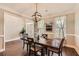 Inviting dining room with hardwood floors, modern lighting, and access to other areas of the home at 125 Murphy Creek Ln, Fayetteville, GA 30215