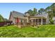 Home exterior showcasing a deck, screened porch, and well-maintained lawn with mature trees at 125 Murphy Creek Ln, Fayetteville, GA 30215