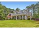 Charming home featuring a brick and siding exterior, complemented by a well-manicured lawn and mature trees at 125 Murphy Creek Ln, Fayetteville, GA 30215