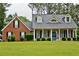 Beautiful two-story home with a brick and vinyl exterior, and a lush green lawn at 125 Murphy Creek Ln, Fayetteville, GA 30215