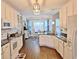 Bright kitchen features white cabinets, dark countertops, pendant lighting and breakfast nook at 125 Murphy Creek Ln, Fayetteville, GA 30215