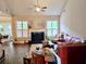 Inviting living room with a cozy fireplace, large windows, and hardwood flooring at 125 Murphy Creek Ln, Fayetteville, GA 30215